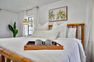 a tray with two cups on a bed at * NEW* The Bungalow Jupiter! - Moremoments Rentals in Jupiter +51 photos