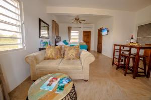 a living room with a couch and a table at The Hidden Cottage in Welches Hill