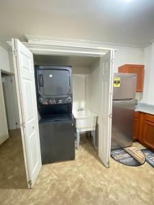 een kleine keuken met een tv en een koelkast bij Kelly's Apartments - Rental near Airport, Amenities and Bus Route in Saint Philip