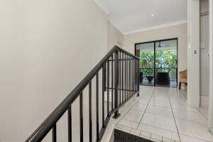 an empty hallway with a staircase in a house at Western Gateway Motel and Apartments in Emerald