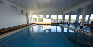 a large swimming pool in a large room at HavsVidden Resort in Geta