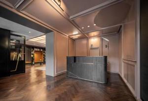 a large lobby with a wooden floor in a building at Mia Hotel - Shanghai Shaanxi South Road in Shanghai