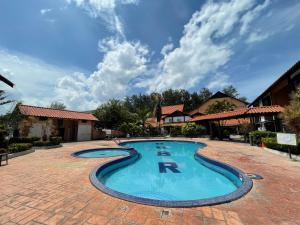 a swimming pool in the middle of a brick patio at DSH Batu Burok Beach Resort in Kuala Terengganu