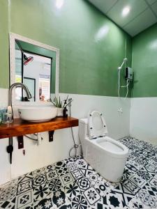 a bathroom with a sink and a toilet at Little Quy Nhơn Homestay in Quy Nhon