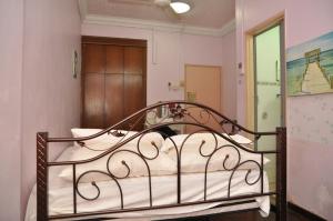 een metalen bed in een kamer met bij 3 Little Birds Home, 100meter to JonkerWalk in Melaka