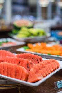 a bunch of plates filled with slices of watermelon at Bella Villa Prima in Pattaya