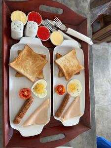 two trays of food with eggs and toast at Ami Mirissa in Mirissa