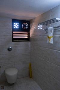 a bathroom with a toilet and a window at Reunion Ocean Royal (Beach House) in Pāngāla +34 photos