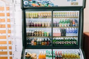 a refrigerator filled with lots of different types of drinks at Group Dome Glamping with Private Hotspring in Lubo