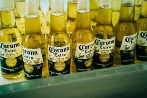 a row of bottles of corona beer on a shelf at Group Dome Glamping with Private Hotspring in Lubo