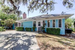a blue and white house with a tree at Light & Bright! Quaint Downtown Dunedin Bungalow! in Dunedin