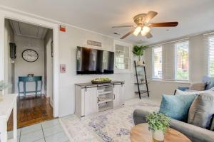 a living room with a couch and a ceiling fan at Light & Bright! Quaint Downtown Dunedin Bungalow! in Dunedin