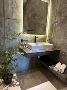 a bathroom with a sink and a mirror at Ami Mirissa in Mirissa