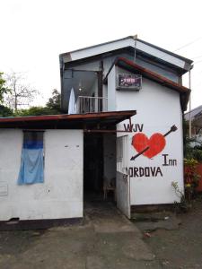 a white building with a red heart painted on it at WJV INN Cordova in Cebu City