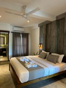 a bedroom with a large bed with a ceiling at Ami Mirissa in Mirissa