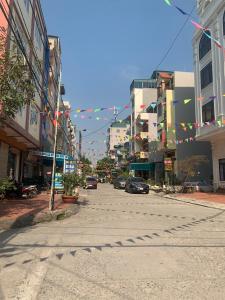 an empty street in a city with flags and buildings at Thanh Tung Hotel in Ha Long