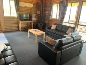 a living room with a couch and a coffee table at Happy Wanderer Holiday Resort The Grampians in Wartook