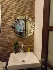 a bathroom with a sink and a mirror on the wall at Eco stay - Luxury pool + Seaview Villa in North Pattaya