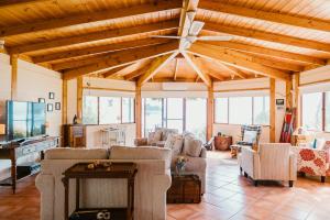 a living room with couches and a ceiling fan at Fleurty's Point Cottage at Franklin South, Huon Valley, Tasmania in Franklin
