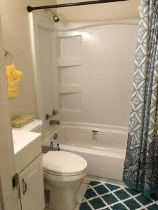 a bathroom with a toilet and a tub and a sink at Suite 4, Sleep 6, Walk to Attractions in Uptown in Charlotte