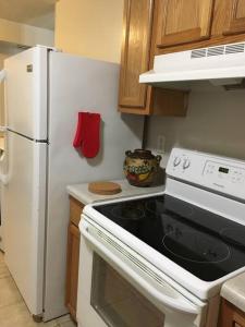 a kitchen with a stove and a white refrigerator at Suite 4, Sleep 6, Walk to Attractions in Uptown in Charlotte