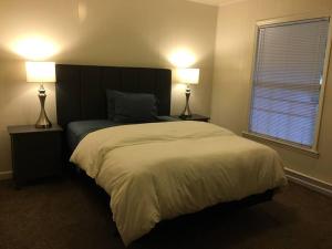 a bedroom with a large bed with two lamps at Suite 4, Sleep 6, Walk to Attractions in Uptown in Charlotte