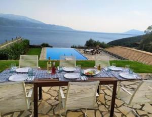 une table en bois avec des chaises et une table avec de la nourriture. dans l'établissement PRINCESS OF BLUE EAGLES RETREAT, à Skaloma