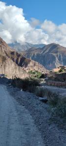 a dirt road in the middle of a mountain at Hostal Milmahuasi Iruya in Iruya