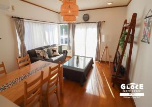 a living room with a table and a couch at GLOCE 養老 西小倉ハウス 2 l 広々とした一軒家を貸切 l 無料駐車場有 l 中長期向け in Yoro