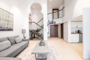 a living room with a couch and a table at Ultra Luxury JBR Duplex Penthouse - Beach Resorts Neighbourhood in Dubai