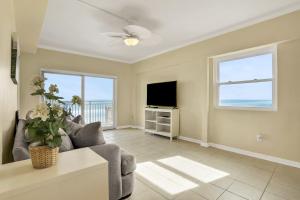 a living room with a couch and a tv at Beachside Surf Haven in Jacksonville Beach