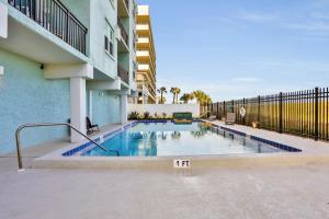 a swimming pool in the courtyard of a building at Beachside Surf Haven in Jacksonville Beach