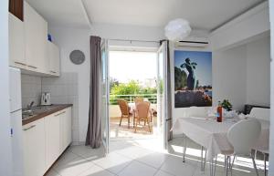 een keuken en eetkamer met een tafel en stoelen bij Apartments Maja 100 from the beach in Podgora