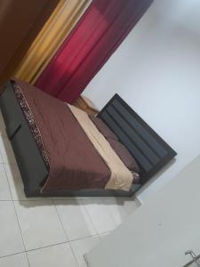 a bed sitting on the floor in a room at Al Karawan Hotel Apartments in Amman