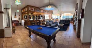 a living room with a pool table in the middle at Hacienda El Galeon in Ensenada