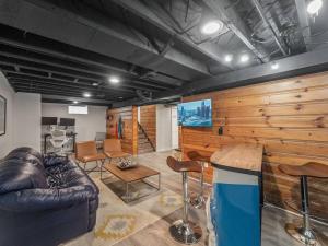 a living room with a leather couch and chairs at Modern Home With A Finished Entertainment Basement in Royal Oak