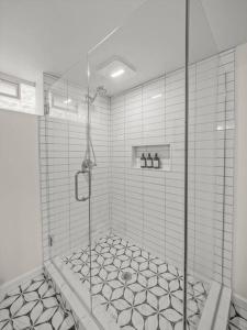 a bathroom with a shower with a tiled floor at Modern Home With A Finished Entertainment Basement in Royal Oak