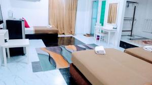a room with two beds and a room with two tables at Fishing Village Marang Terengganu in Marang