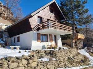 a house with a stone wall in front of it at Appartement au RDC d'un Chalet - Proche Ski/Randonnées - Terrasse Sud - 4 pers - FR-1-393-150 in Saint-Michel-de-Chaillol