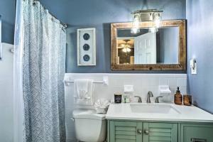 a bathroom with a sink and a mirror at NEW! Cheerful bungalow with hot tub near beaches in Bay Pines +17 photos