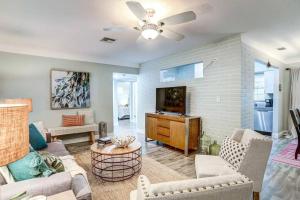 a living room with a couch and a flat screen tv at NEW! Cheerful bungalow with hot tub near beaches in Bay Pines
