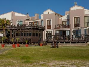 Langstrand的住宿－燃燒的海岸酒店，前面一排房子,上面有草坪