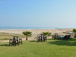 - un groupe de tables et de chaises sur la plage dans l'établissement Burning Shore Hotel, à Langstrand