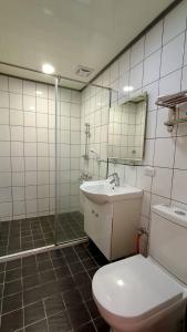 a bathroom with a toilet and a sink and a shower at Xitou Tianpin Homestay in Lugu Lake