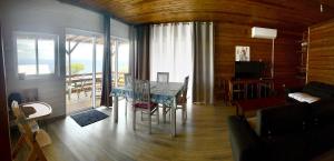 a dining room with a table and a living room at Alambic de Grand Anse in Petite Île