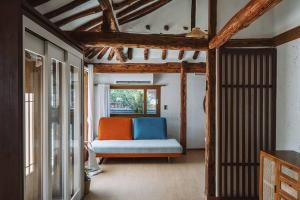 a living room with a couch and a window at Hanokstay Haru in Jeonju