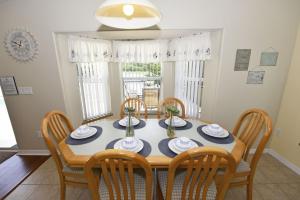 a dining room with a table and chairs at Lovely Lakeside 4-Bed Pool Home at Villa Sol-3125 home in Kissimmee