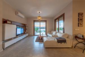 a living room with a couch and a flat screen tv at BYTK - La Casa Del Sol in Hurghada