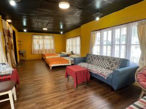 a living room with a couch and a bed at Hometown & Bungalow in Da Lat