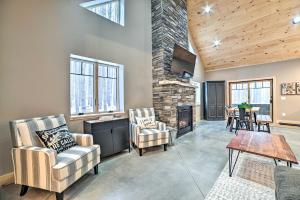 a living room with two chairs and a fireplace at Bellaire Cabin, 1 Mi to Schuss Mountain! in Bellaire